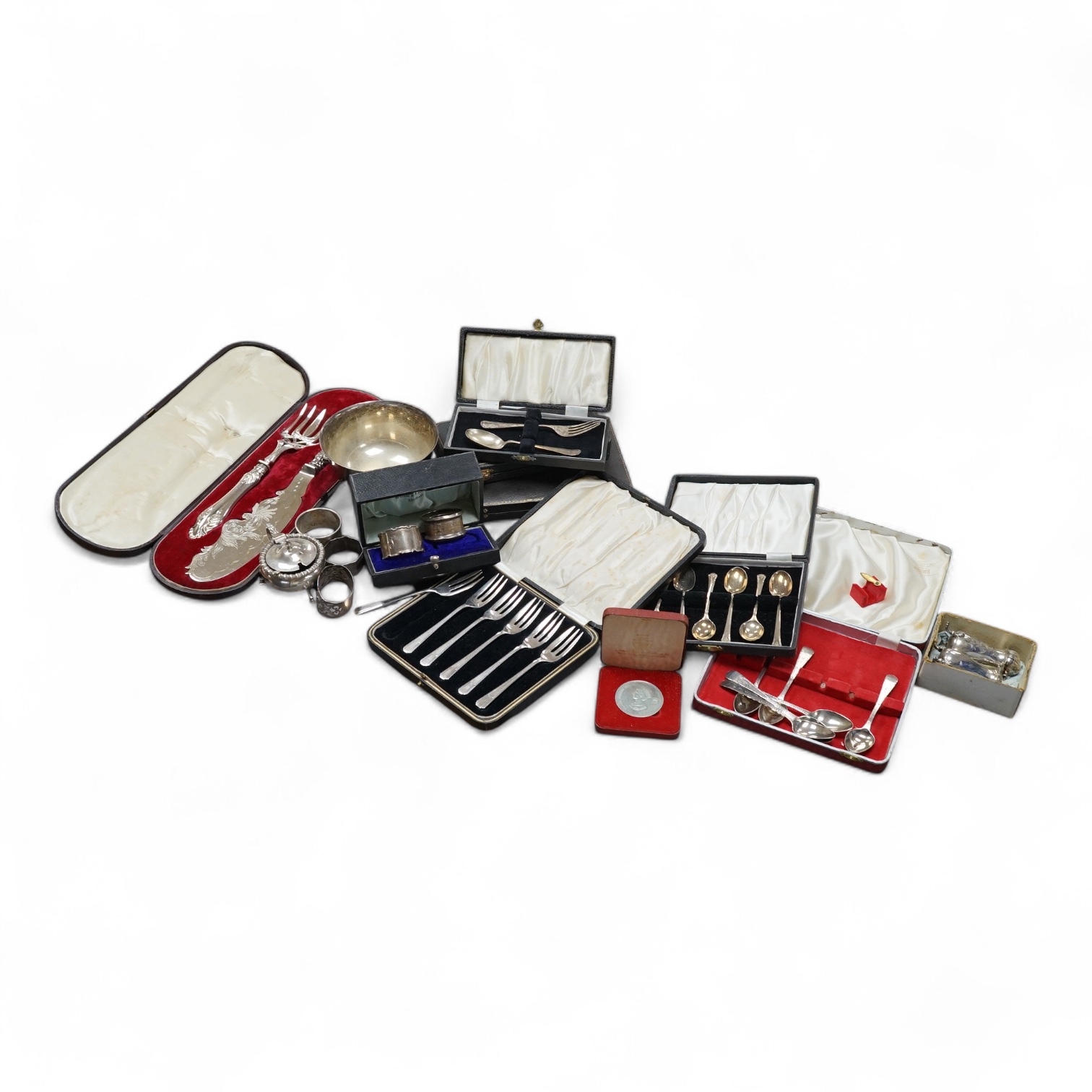 Six assorted cased sets of silver flatware (one incomplete) including a set of six George III, London, 1794, together with four silver napkin rings, a sterling napkin ring, three silver condiments, a cased commemorative